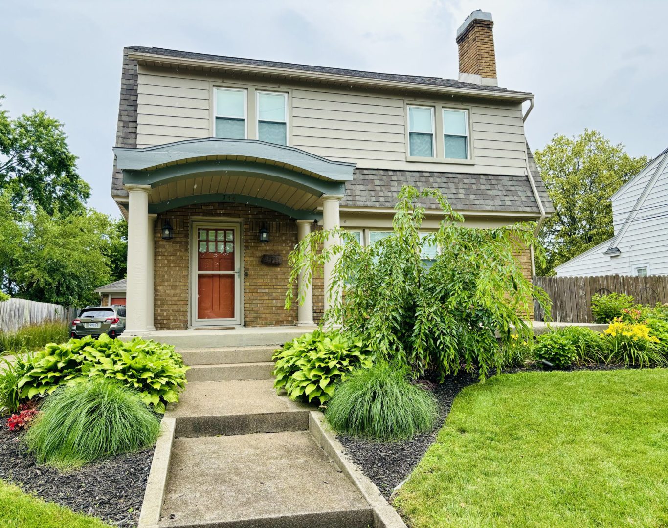 Professional exterior house painting project in Grand Rapids, MI, showcasing a beautifully updated home.